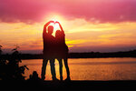 silhouette-of-loving-couple-standing-riverside-and-beautiful-sunset-background.jpg