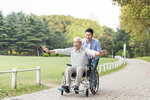 lovepik-elderly-father-and-son-happy-pushing-wheelchair-picture_501270087.jpg