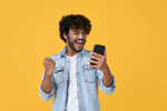 excited-young-indian-man-winner-using-smartphone-isolated-on-yellow-background (1).jpg