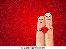 happy-couple-in-love-with-painted-smiley-holding-red-heart-stock-images_csp12309256.jpg