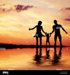 happy-family-walking-together-hand-in-hand-at-sunset-mother-father-and-a-little-child-WK678H.jpg